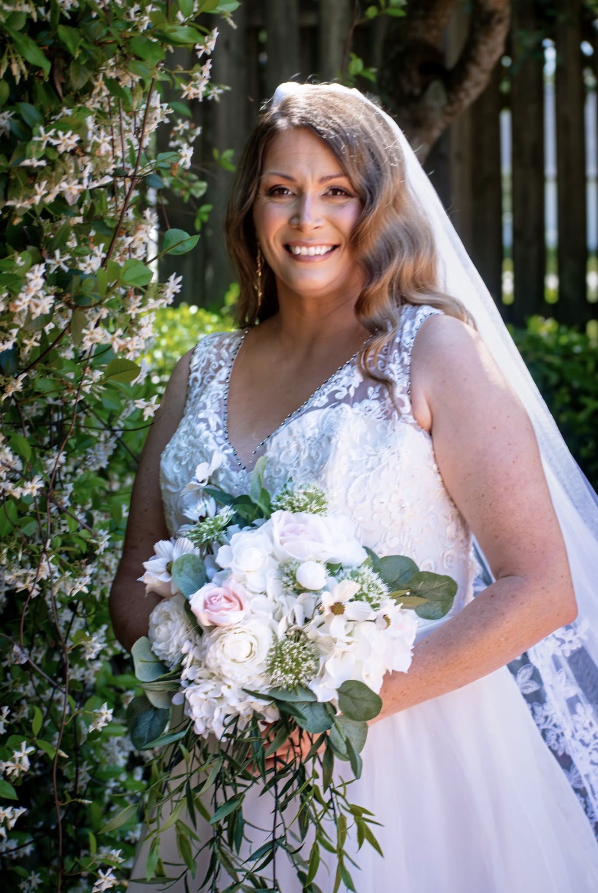 Real bride — natural bridal makeup and soft waves in a sunlit garden
