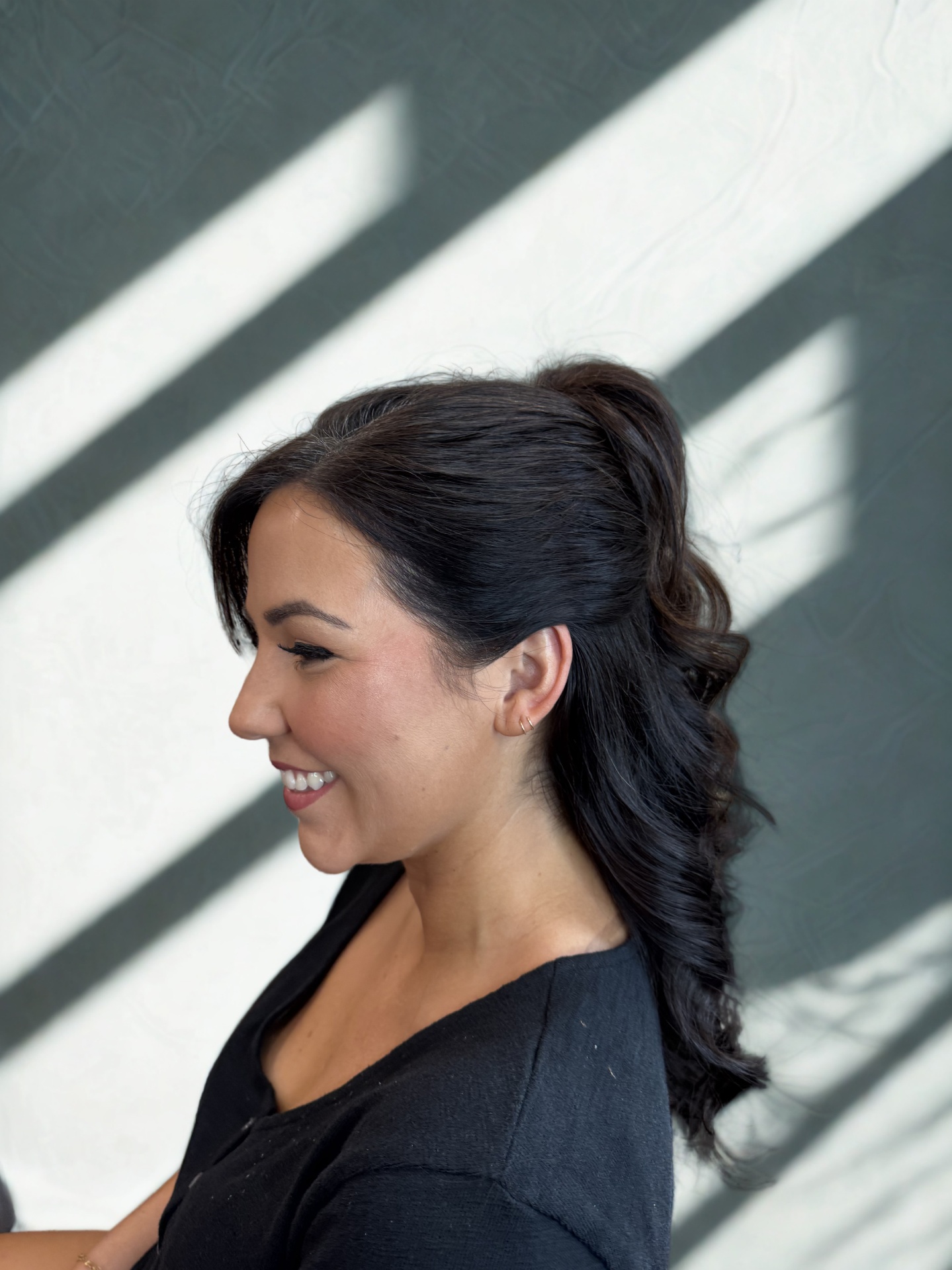 Real client — voluminous curled high ponytail with soft glam makeup